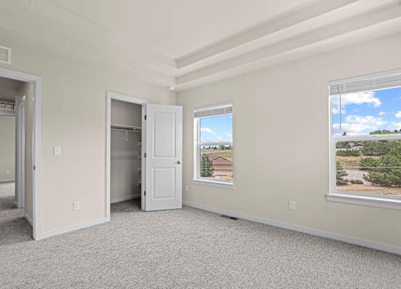 Room with a large window and a view of a residential area outside at The Townhomes at Pine Drive, Colorado, 80138