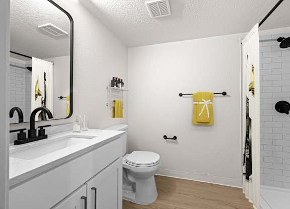 A bathroom with a toilet, sink, and shower at Tallmadge Lofts in Denver, CO