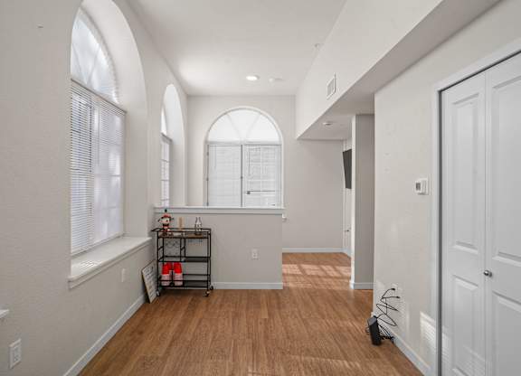 A room with wooden floors and white walls.
