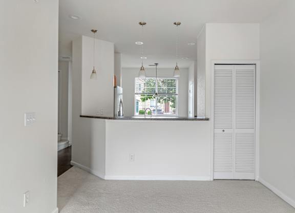 A white room with a window and a counter.