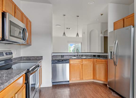 A kitchen with wooden cabinets and stainless steel appliances.