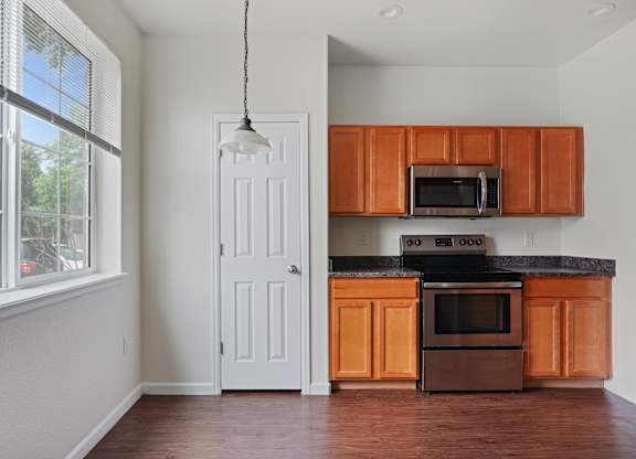 A kitchen with wooden cabinets and a black stove top oven.