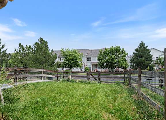 A view of a green lawn from a house.