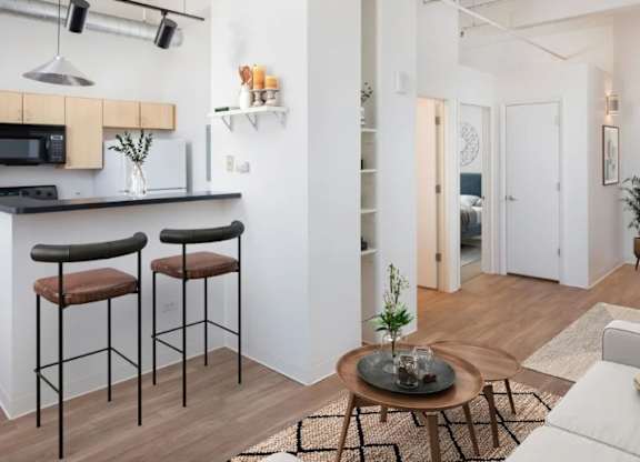 A modern kitchen with a bar area and a dining area.