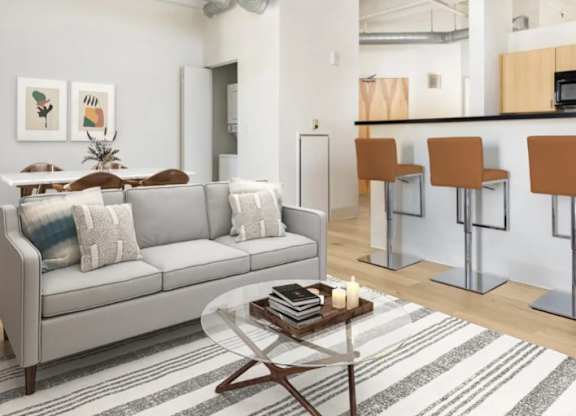 A living room with a grey couch and a coffee table.