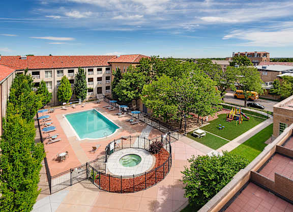 A view of a pool and playground area from a high angle.