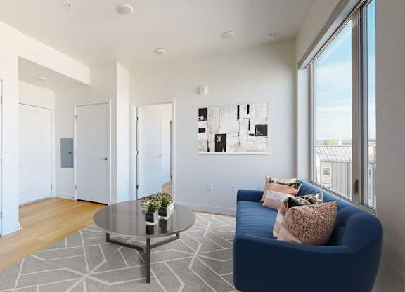 Living Room with Blue Couch at Proto Apartments, Denver, Colorado