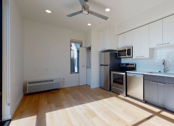 Kitchen with White Cabinets at Proto Apartments, Denver, CO