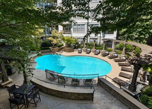 a large swimming pool in front of a hotel