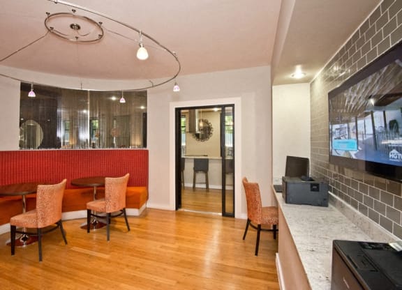 a lobby with a table and chairs and a television