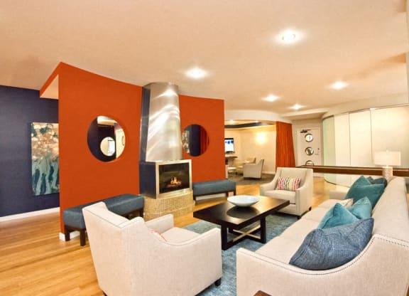 a living room with couches and chairs and a fireplace