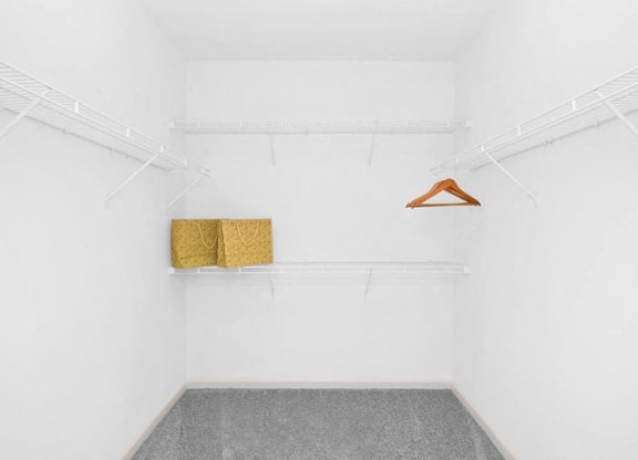 a white room with two shelves and a hanger on the wall