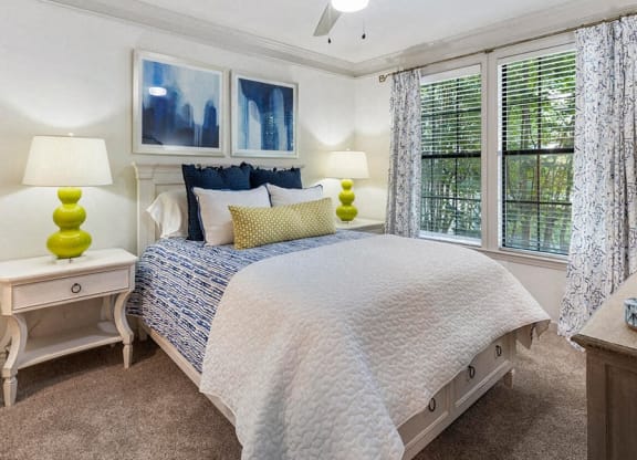 a bedroom with a bed and three windows