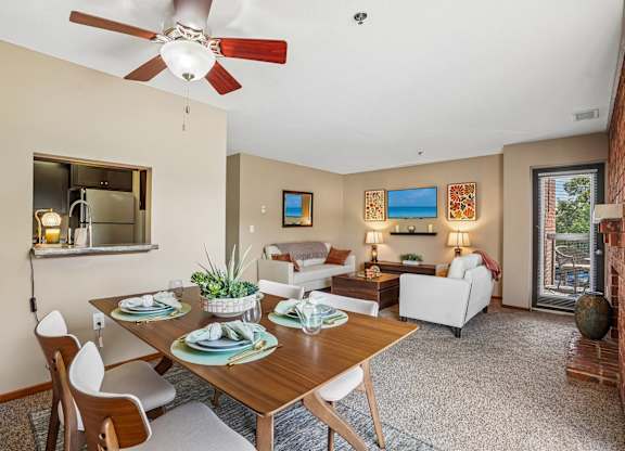 A dining room with a table set for four.