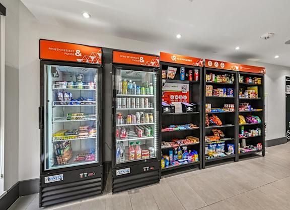 Two large refrigerators with orange labels and a variety of products inside.
