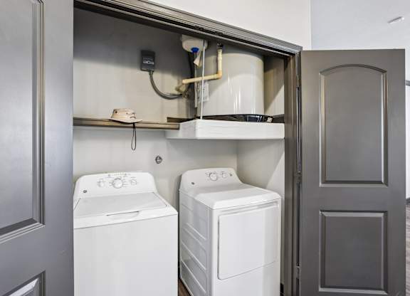 A washer and dryer are installed in a wall-mounted cabinet.