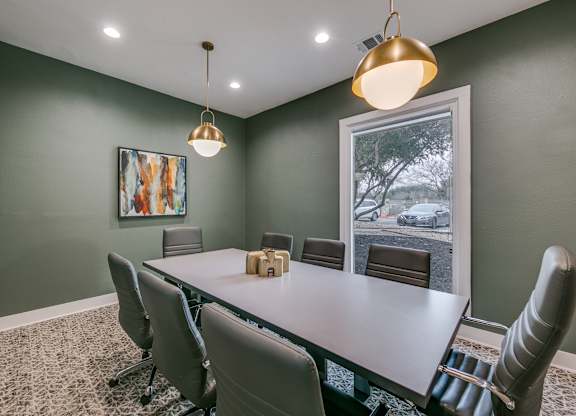 a conference room with a table and chairs and a window at Canyon Ridge, Texas
