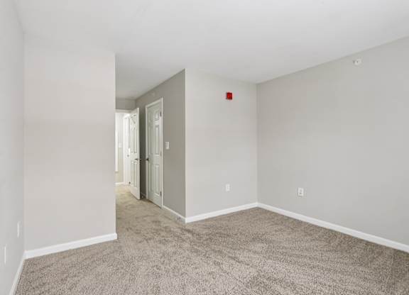A room with carpeted floor and white walls.