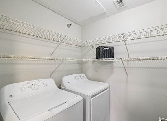 A small laundry room with a washer and dryer.