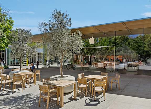 A large outdoor seating area with wooden tables and chairs.