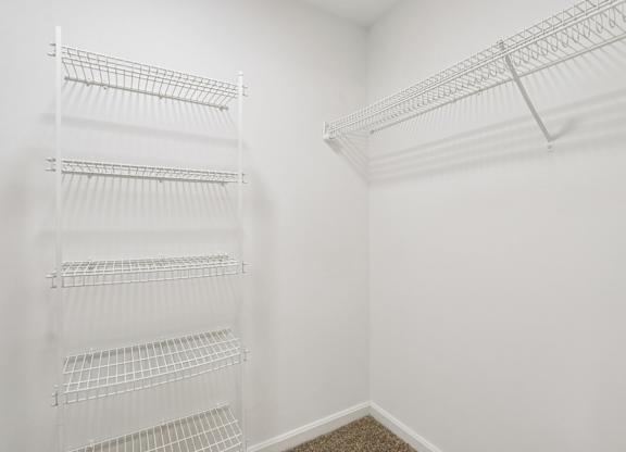 Empty white shelves in a room.