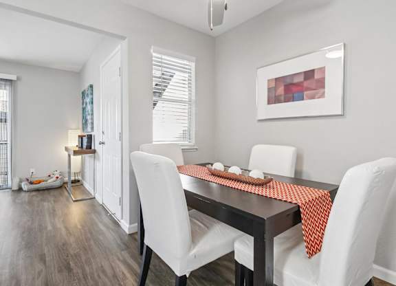A dining room with a table set for two.