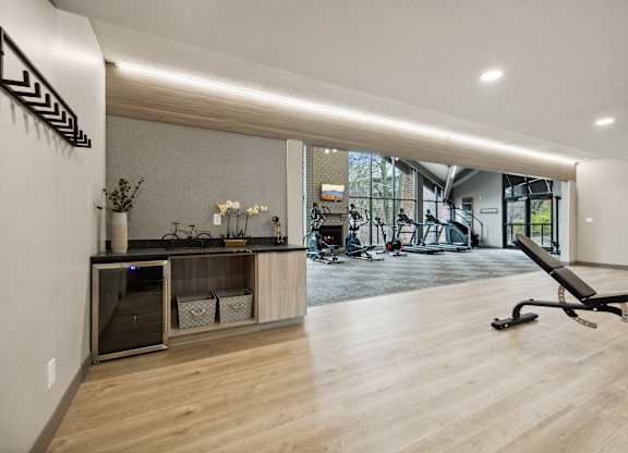 a gym with a desk and a chair in the middle of a room