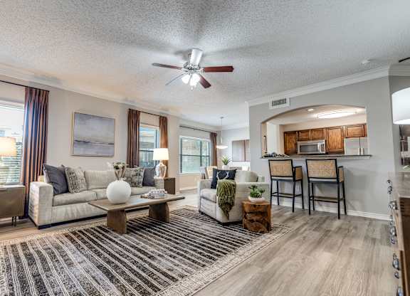 A living room with a couch, chairs, and a coffee table.