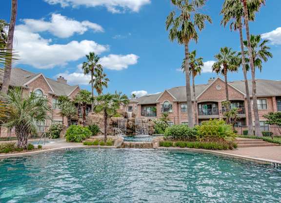 Apartments For Rent In West Houston, TX - San Montego - Tropical Lagoon Style Pool With Hot Tub, Fountains, Palm Trees, And Maintained Landscaping