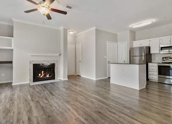 Apartments for Rent in Plano - Carrington Park - Open-Concept Living Area with Vaulted Ceilings, Beige Carpeting, and Sliding Glass Doors Leading to the Patio/Balcony