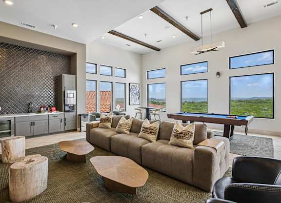 A living room with a brown couch and a wooden coffee table.