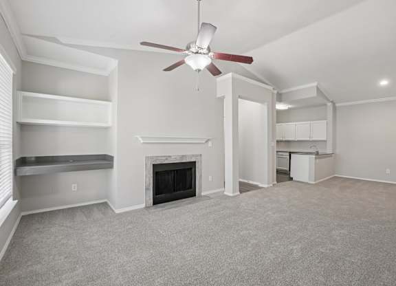 A living room with a fireplace and a ceiling fan.