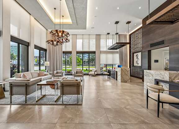 A modern living room with a large chandelier and a marble floor.