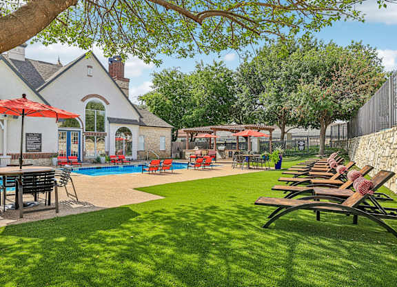 A pool area with a building in the background.