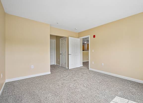 A room with carpeted floor and white walls.
