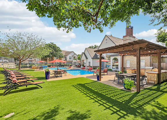 A backyard with a pool and a gazebo.