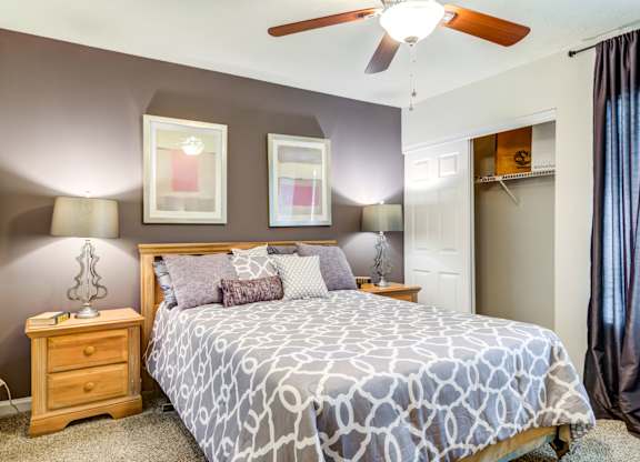 Pet Friendly Apartments in Roswell, GA - 2200 Big Creek Apartments -  Bedroom with large bed and ceiling fan