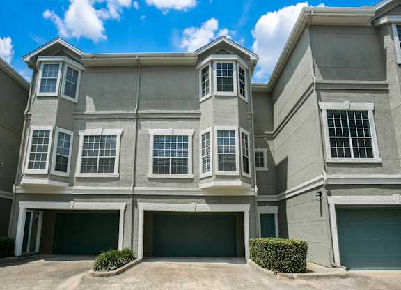 Houston Townhomes - The Maroneal - Exterior View of Townhome with Private Garage, Large Windows, and Greenery
