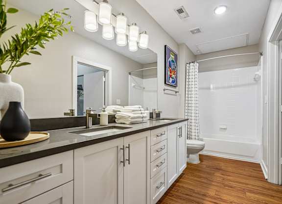 A bathroom with a white toilet and a white shower.
