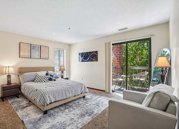 A bedroom with a large bed and a couch.