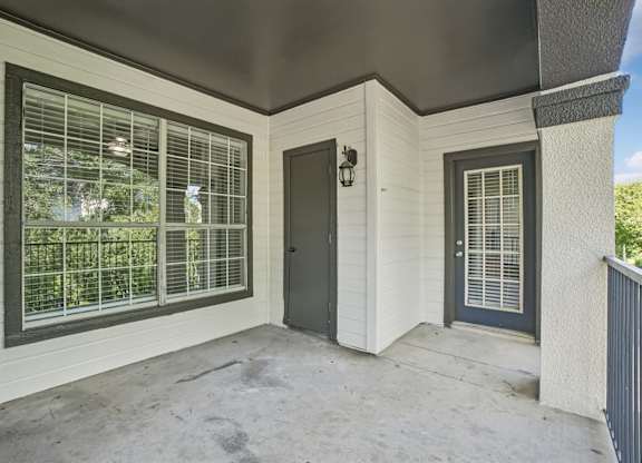 A small white house with a black door and window.