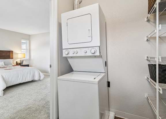 A white oven is in a kitchen next to a bedroom.
