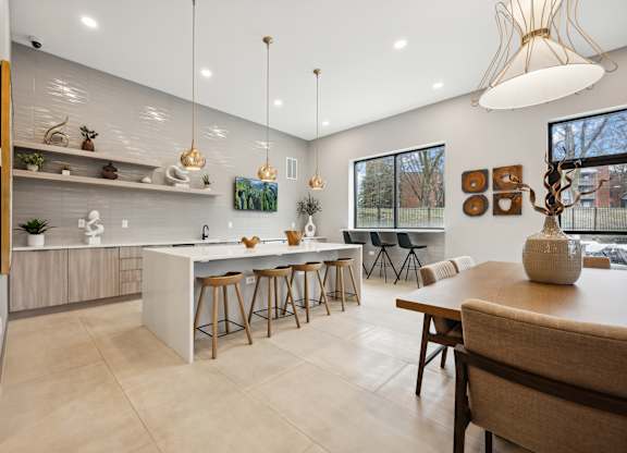 a kitchen and dining area with a table and chairs