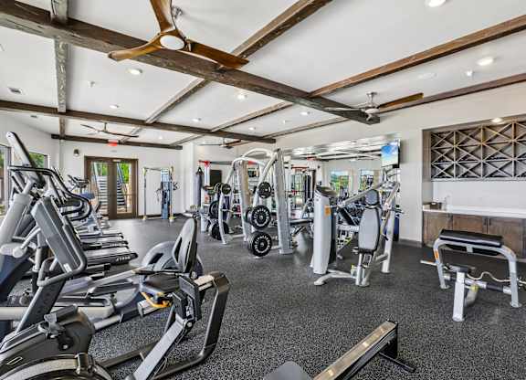 A gym with treadmills, weights, and other exercise equipment.