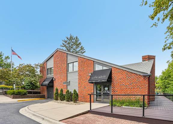 A brick building with a black awning and a sign that says