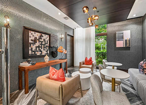 A living room with a grey couch, a wooden table, and a chair.