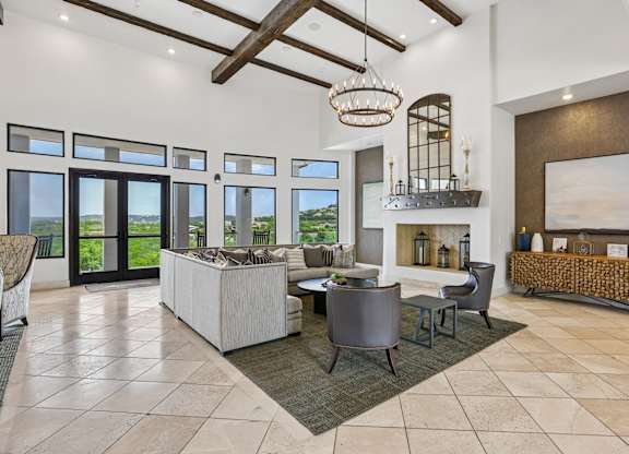 A modern living room with a large sofa set and a fireplace.