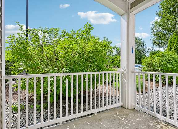 A white gate with a blue sign on it.