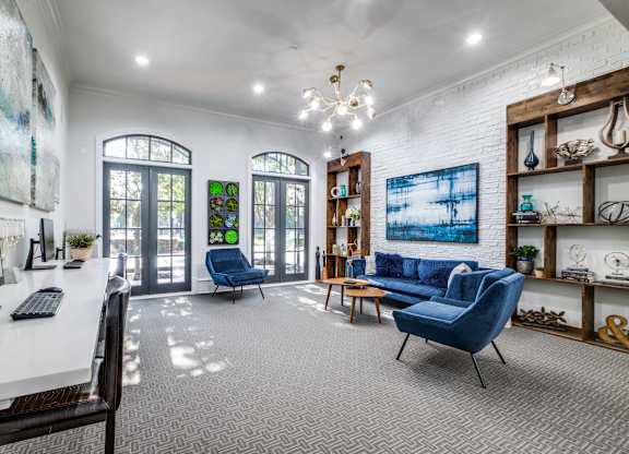 A room with a white desk and a blue chair.