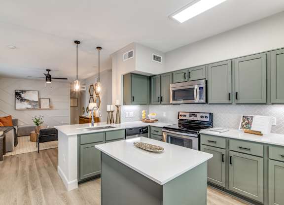 A modern kitchen with a large island in the center.